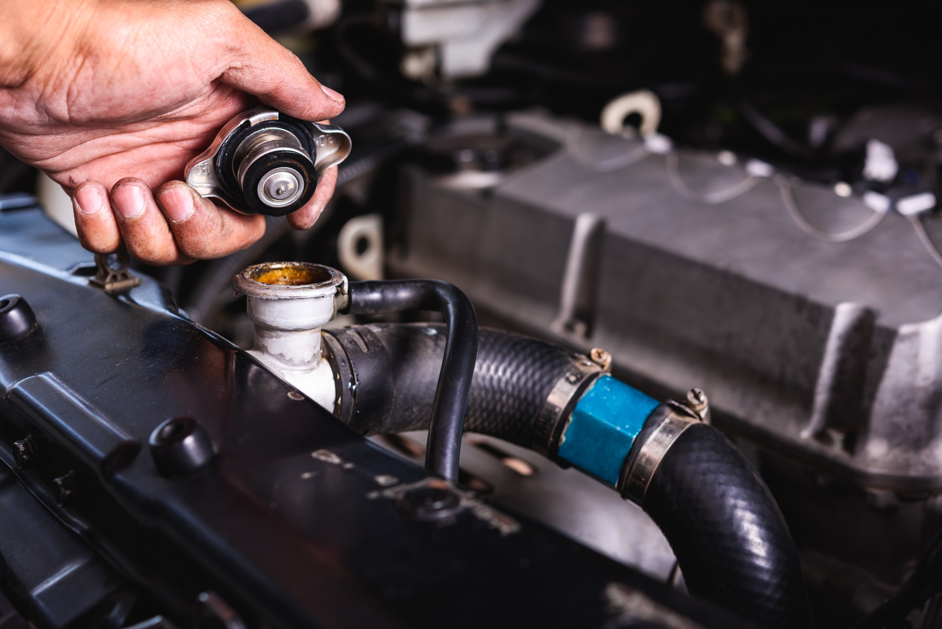 Hand of auto mechanic technician service check cooling water he open radiator cap